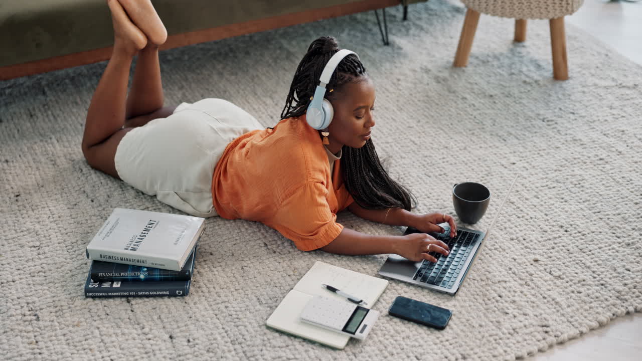 Laptop, headphones and young woman on the floor