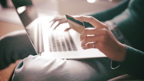 a woman holding her bank card while using