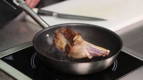 cooking lamb shank in a pan