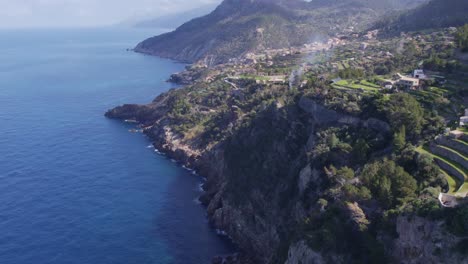 reveal shot of torre del verger and coast of banyalbufar touristic town in mallorca, aerial