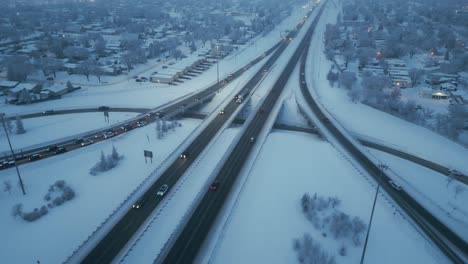 drone shot, as rush hour occurs, over a freeway during a foggy overcast winter evening