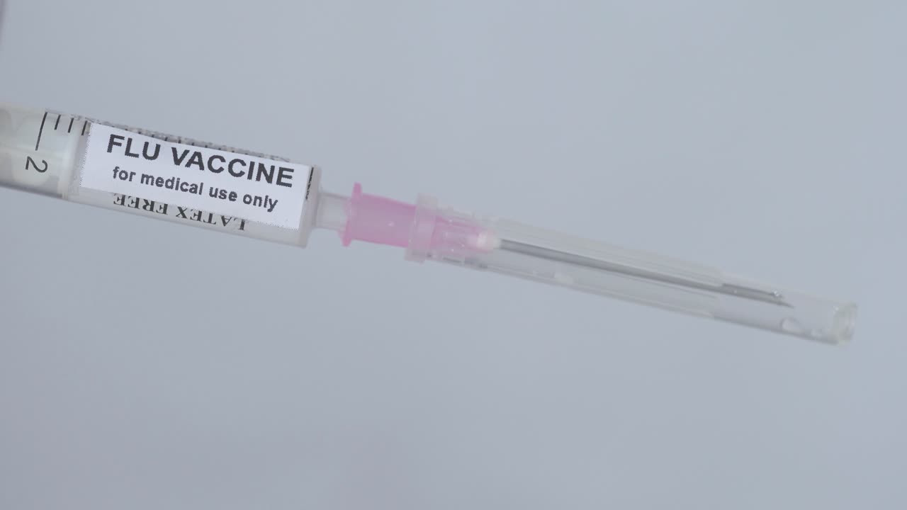 Medical Man Removing The Needle From Injection Filled With Flu Vaccine, Close Up Shot