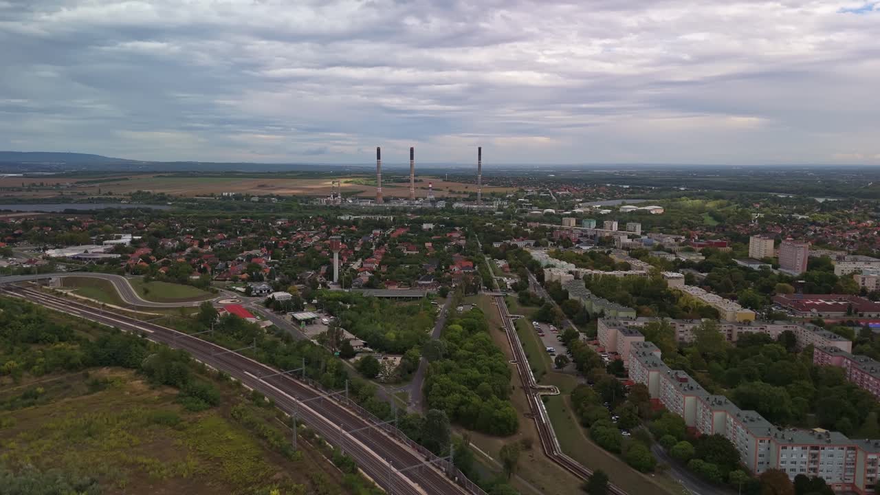 Százhalombatta aerial skyline with the Danube power plant and tall chimneys behind the local houses on a cloudy day in Hungary