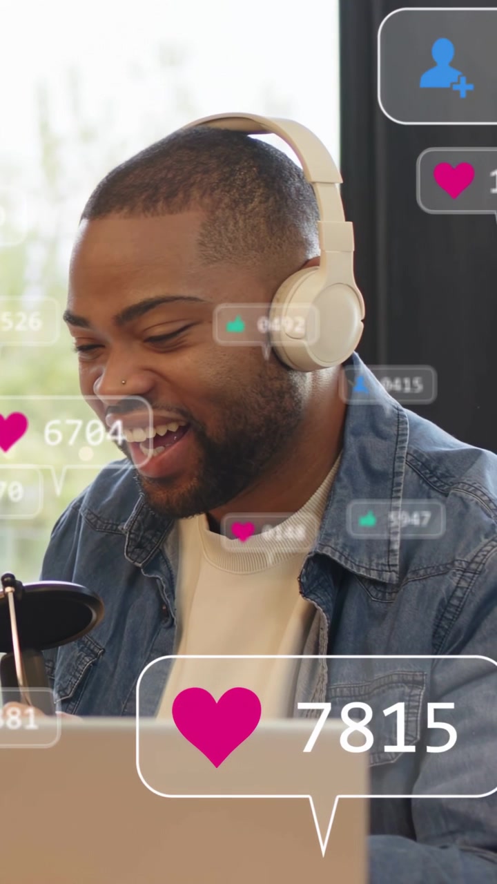 Vertical video: Streamer speaking into mic, likes rising, him leaning in and smiling for engagement
