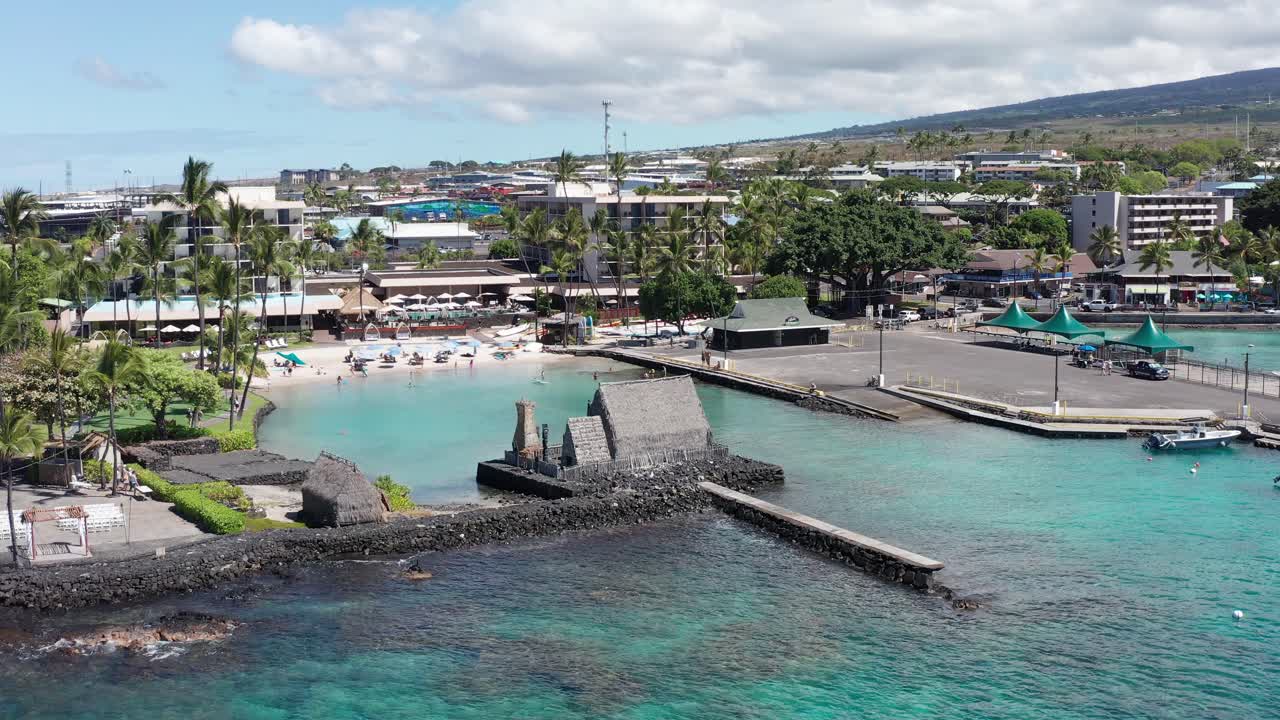 Low panning aerial shot of the historic Kamakahonu House, ancestral home of King Kamehameha I in Kailua-Kona, Hawai'i