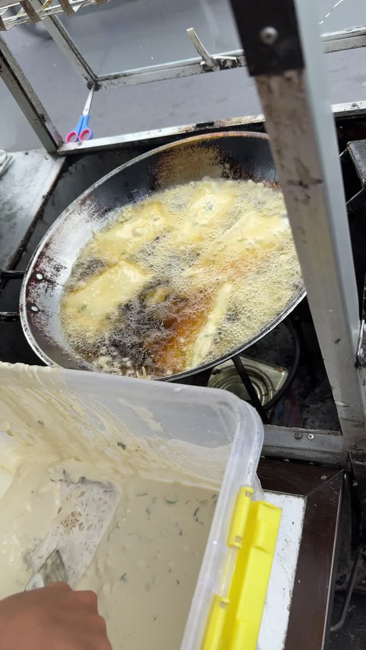 Street Food Vendor Frying Fritters in Hot Oil