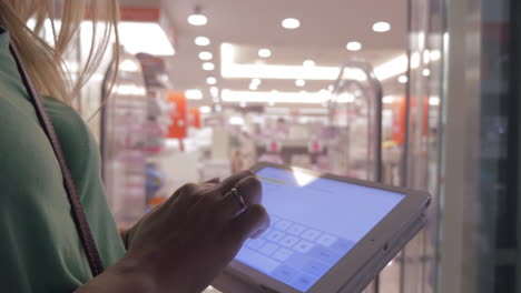 Woman-with-pad-in-hypermarket-lift