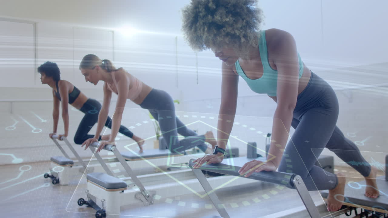 Exercising on reformer machines, women using digital interface for animation display