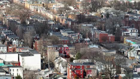 long aerial zoom of tight housing in urban american city