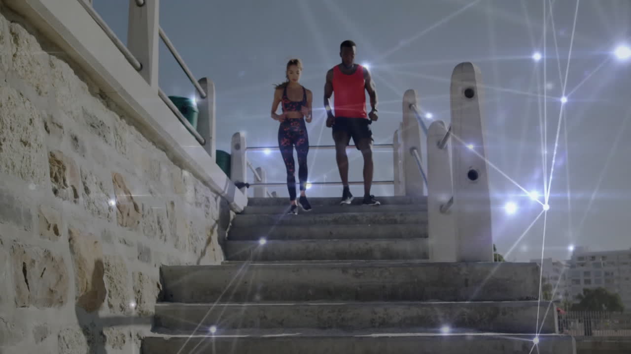 Walking down stairs, two people with digital network animation overlay in school