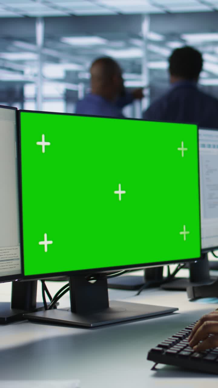 Vertical video Software developer in server farm safeguarding against hackers with mockup PC