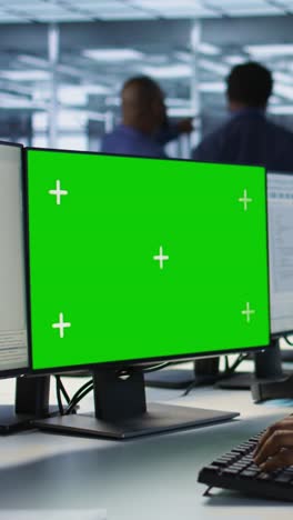 vertical video software developer in server farm safeguarding against hackers with mockup pc