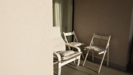 revealing some chairs and armchair in a sunny corner of the terrace of a house