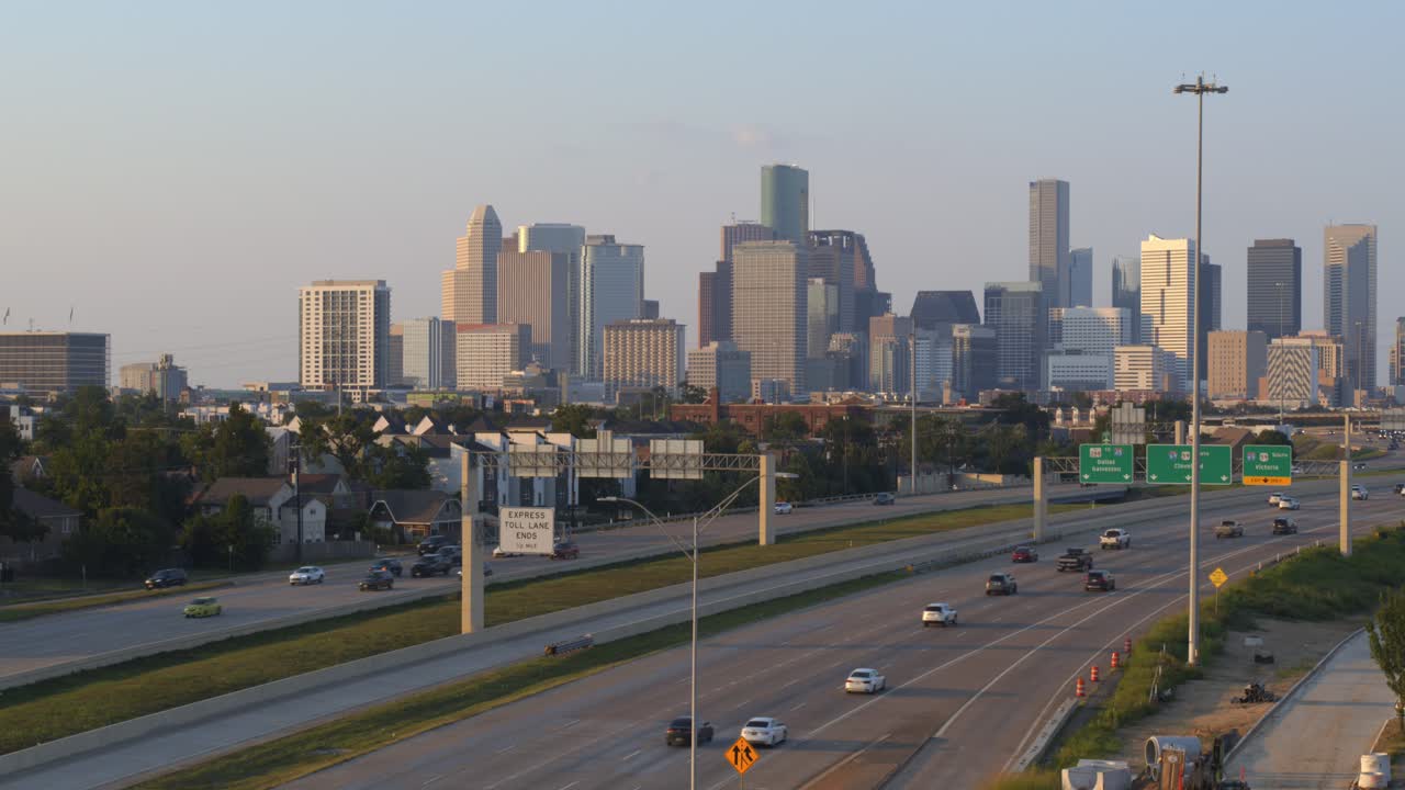 Ascending drone shot of 288 Freeway Traffic with Houston Cityscape