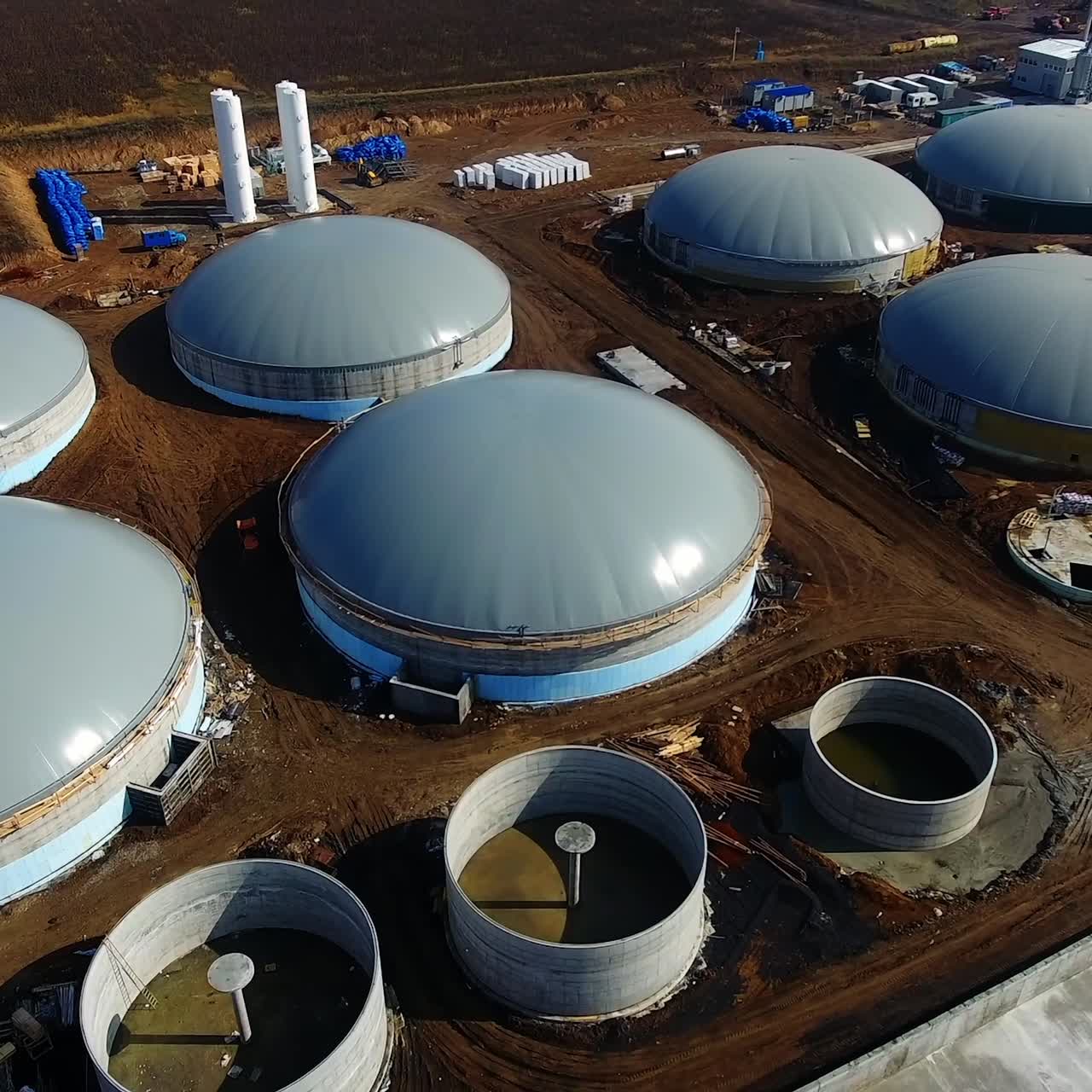 Bio gas factory out of town buildings. Many fans ventilate room. Ecologic biofuel