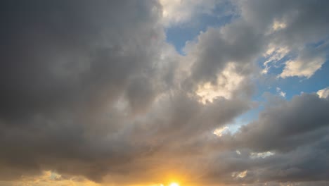 time lapse golden sunset in cloudy sky.