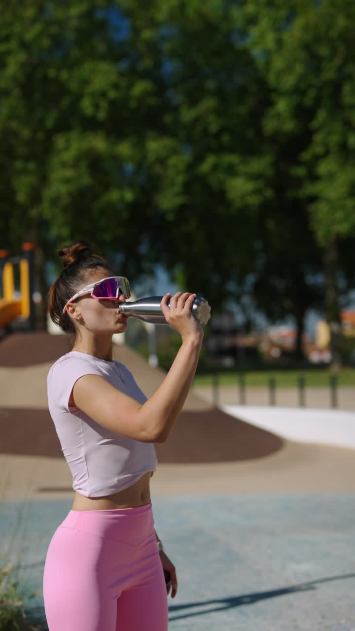 Woman in a park drinking water