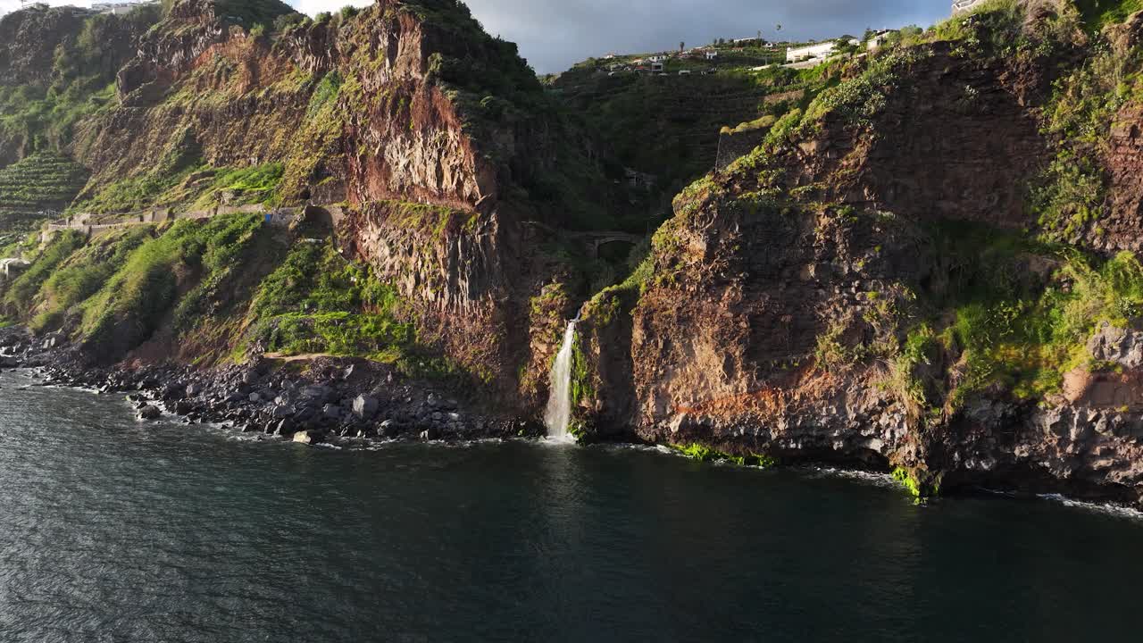 Coastal drone view as Cascata do Mito at Ponto do Sol Madeira plunge into ocean