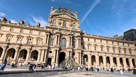 visitors exploring the louvre museum courtyard