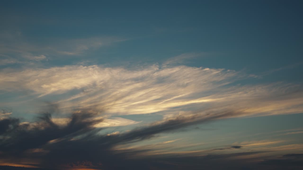 Time lapse of a beautiful scenic red sky after the sunset over the city and growing dramatic dark rainstorm clouds, golden hour, afterglow, wide shot