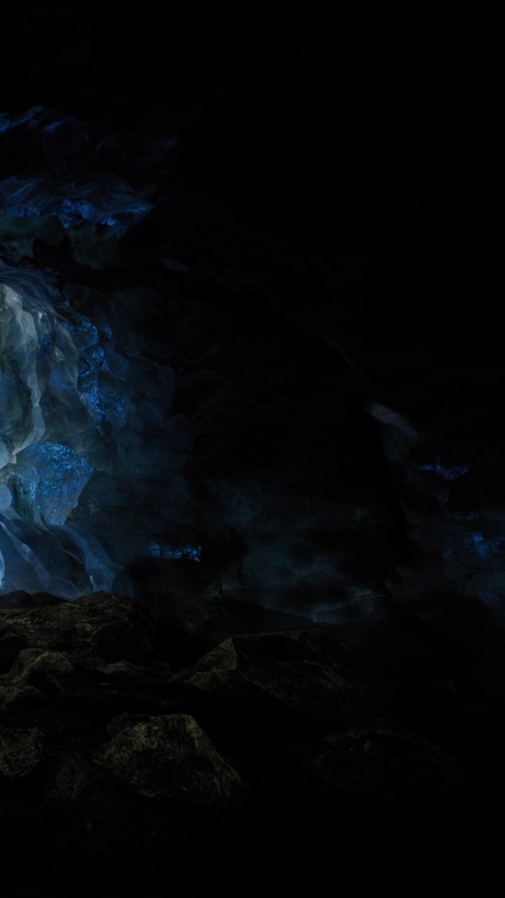 Cave with blue light and rock formations during nighttime exploration