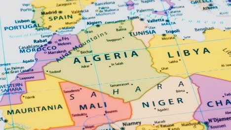 close-up of the country words algeria and libya on a world map with the detailed name of the capital city