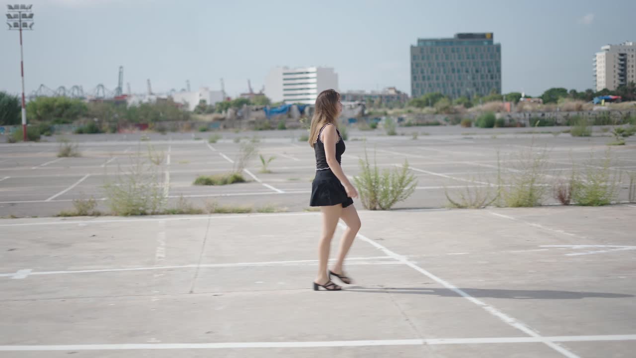 Woman Walking in an Empty Parking Lot