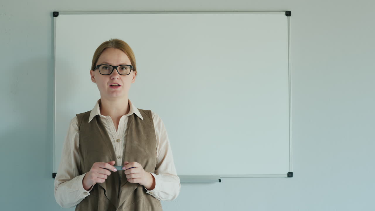un maestro cerca de un tablero en blanco da una lección