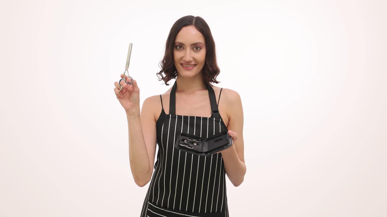 A woman holding scissors and an apron