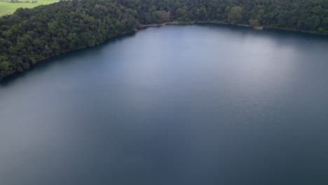 serene water of lake eacham in atherton tableland, queensland, australia - aerial drone shot