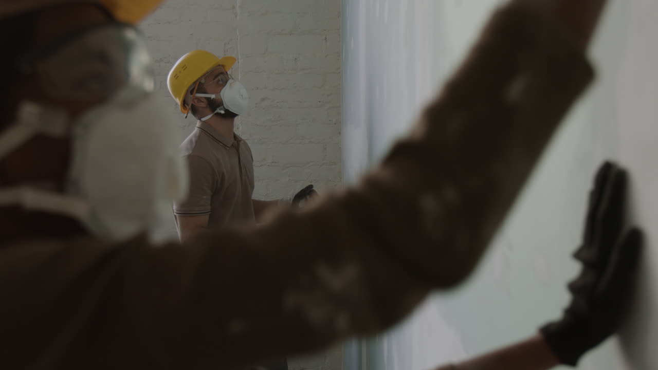 Construction workers repairing a wall