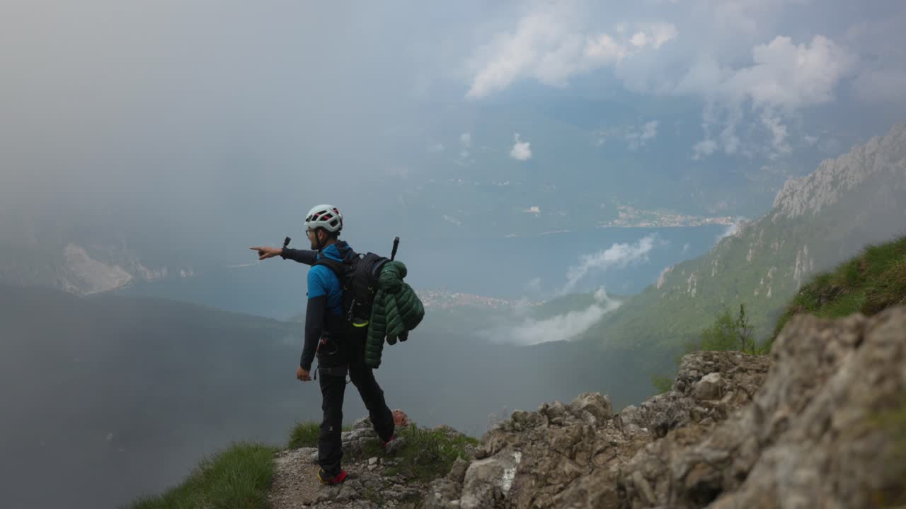 A Mountain Climber Standing Atop the Peaks of Mount Grignetta in Lombardy, Italy - Medium Shot