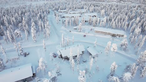 aerial drone flying through snow covered neighborhood in lapland, finland, arctic circle