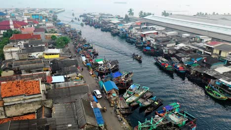 static-drone-video-of-a-busy-and-hectic-indian-town-harbour-during-the-start-of-the-working-day-filled-with-tourists-and-locals-working-and-enjoying-the-Hussle-of-the-estuary