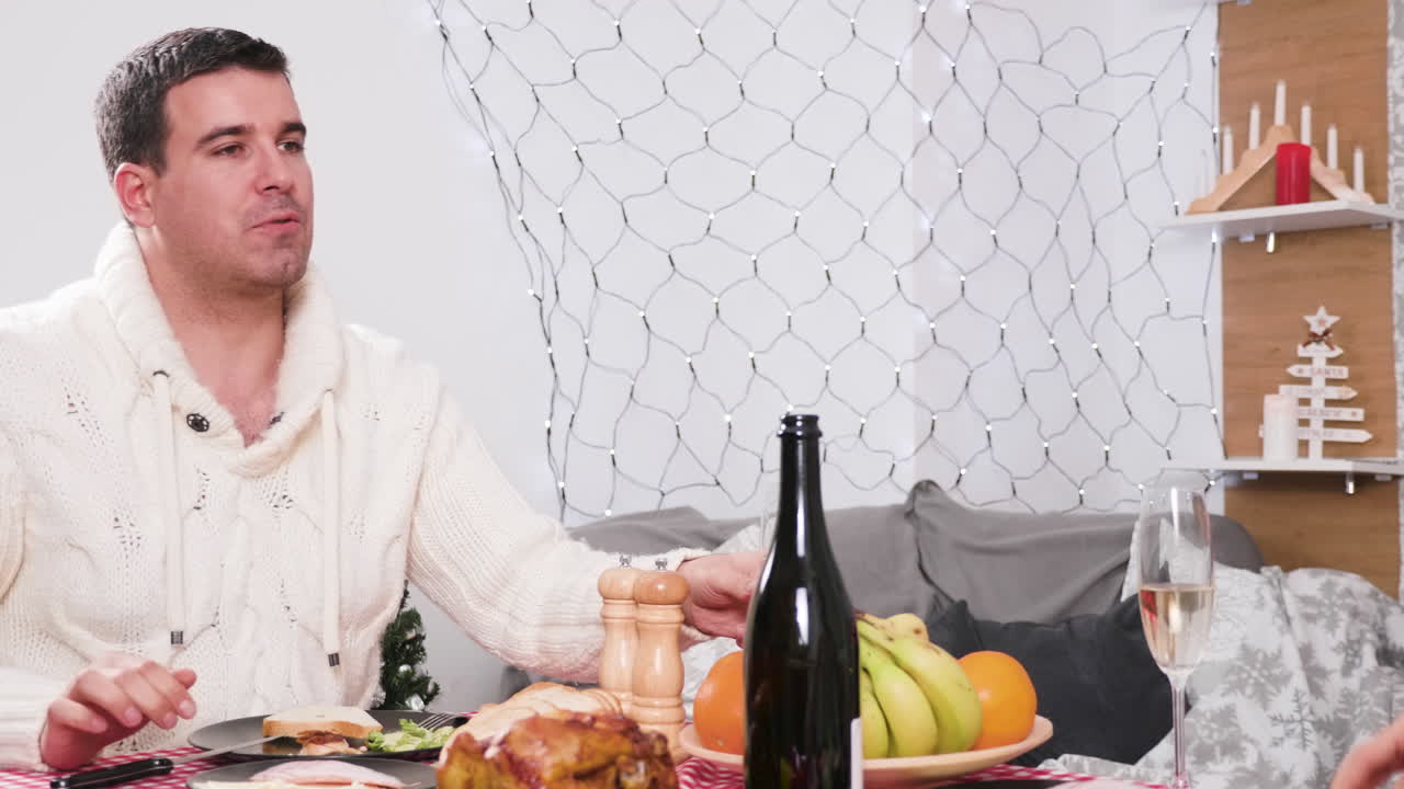Couple celebrating Christmas with dinner and champagne
