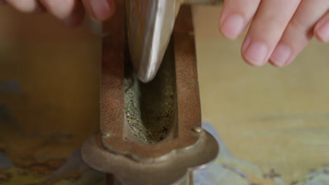 Grinding-tea-with-a-grinder-preparing-the-traditional-Chinese-tea-ceremony