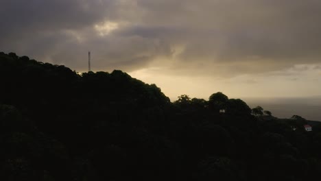 Sao-Jorge-island,-Azores,-Portugal-view-with-truck-camera-movement-from-vegetation-during-sunrise-golden-hour-with-houses-bellow-High-quality-4k-drone-footage