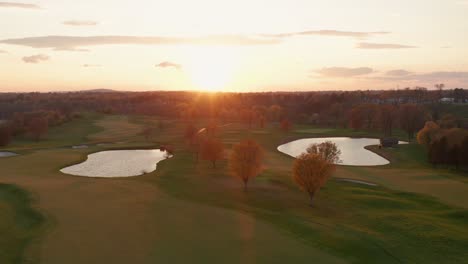 aerial of golf course at sunrise, sunset