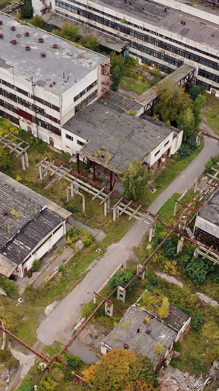 Abandoned ruined factory building architecture. Industrial destroyed city buildings. Vertical video