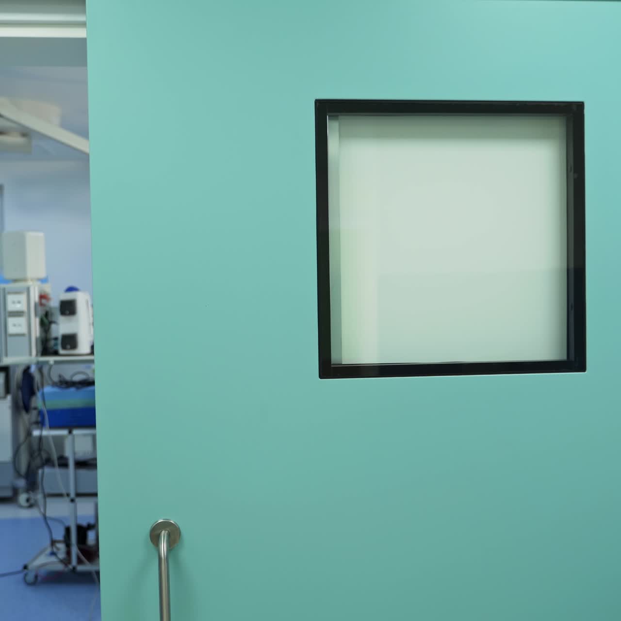 Surgeons stand near the patient and talk. Medical staff preparing the surgery room for operation. Camera slowly goes out of the operation room