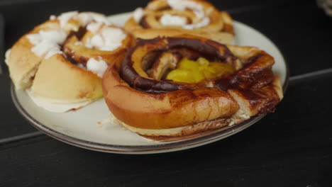 close up of fresh scandinavian cinnamon buns on a plate outdoors