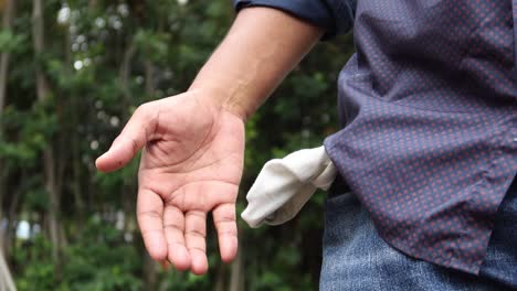 young man shows empty pant pocket with copy space