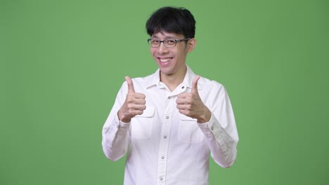 young asian businessman excited while giving thumbs up