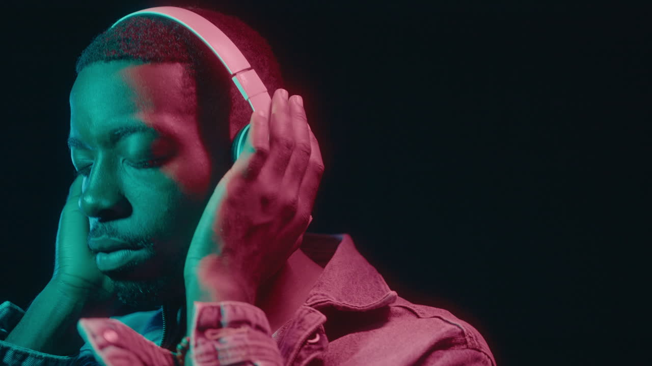 Black Guy with Headphones Vibing in Neon Light