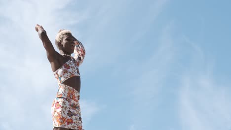 happy black non-binary person dancing on street and enjoying freedom