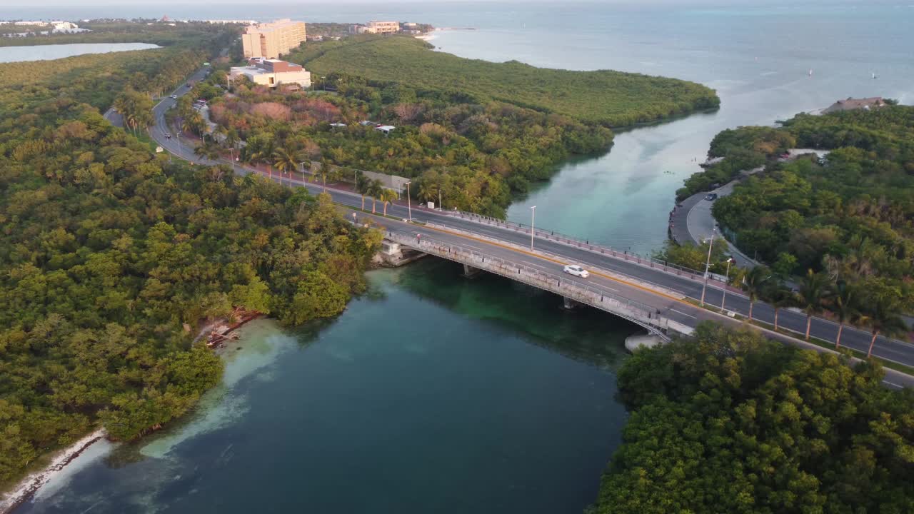 Aerial view of Punta Nizuc bridge with cars driving towards hotel zone of Cancun, Mexico