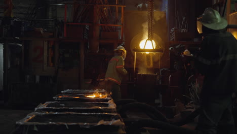 dynamic industrial foundry scene showcasing the pouring of glowing molten metal, with focused workers in protective safety gear amidst showers of sparks