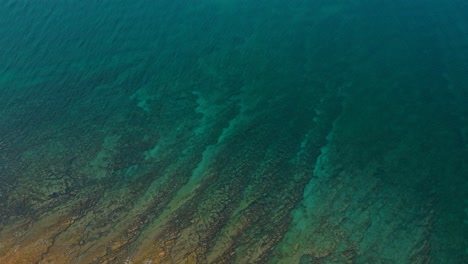 Cinematic-ocean-rock-reef-water-as-bird-view-in-Istria,-Croatia