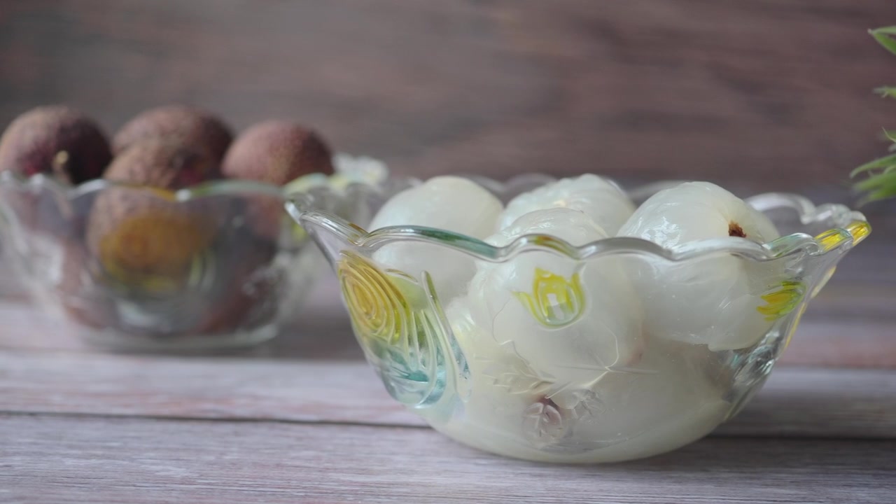 Peeled Lychee Fruits in a Glass Bowl on a Wooden Table