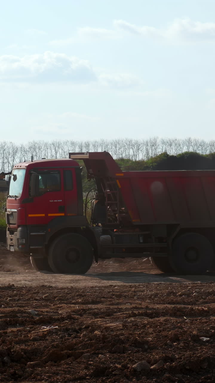 Dump truck and excavator at construction site